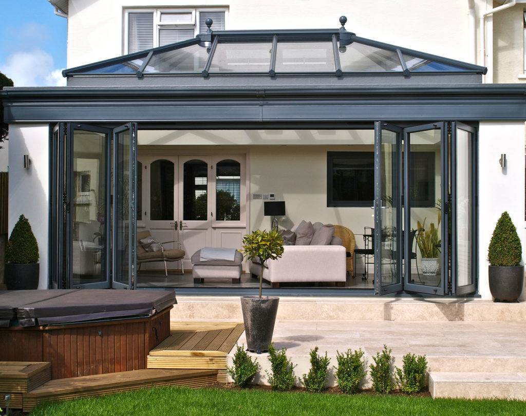Bi-fold doors on the front of the conservatory of a beautiful house